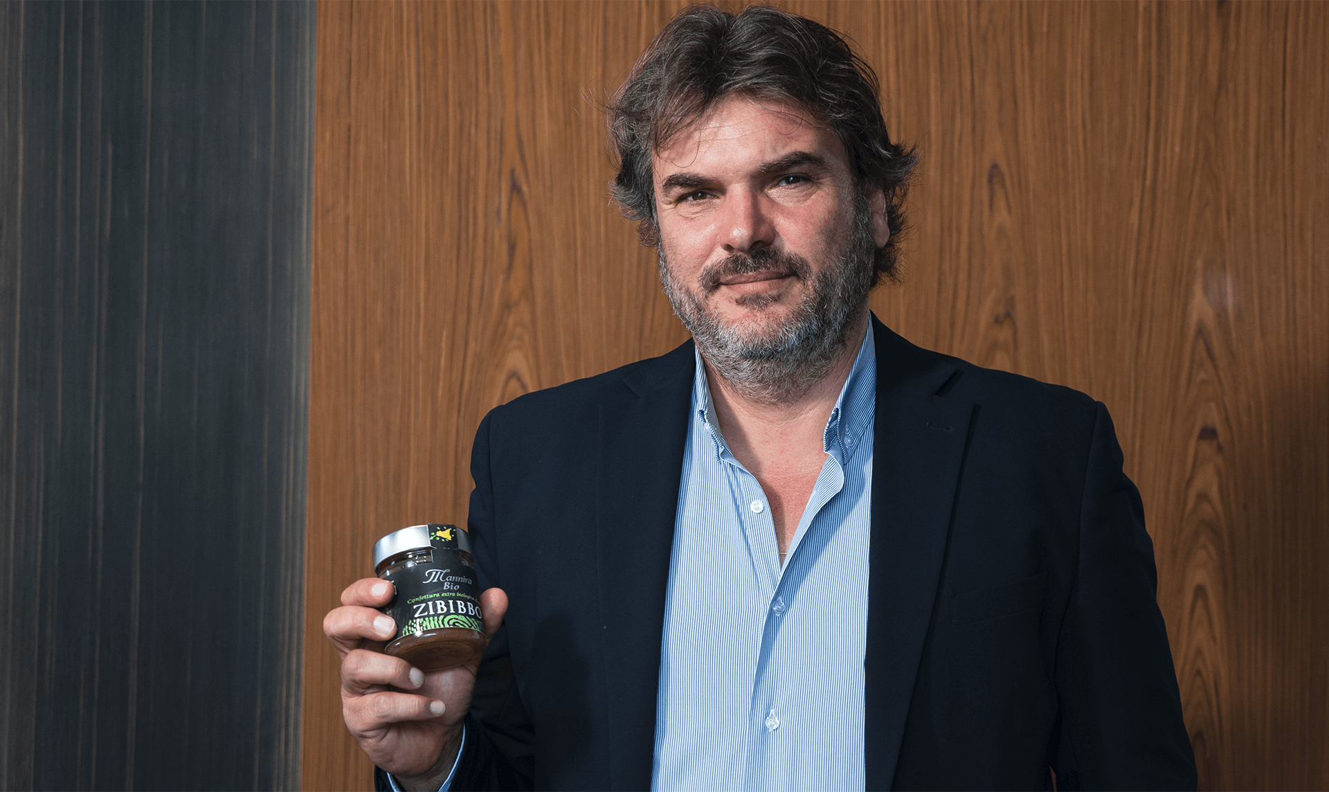 Uomo che tiene in mano la confettura extra Mannirà Bio